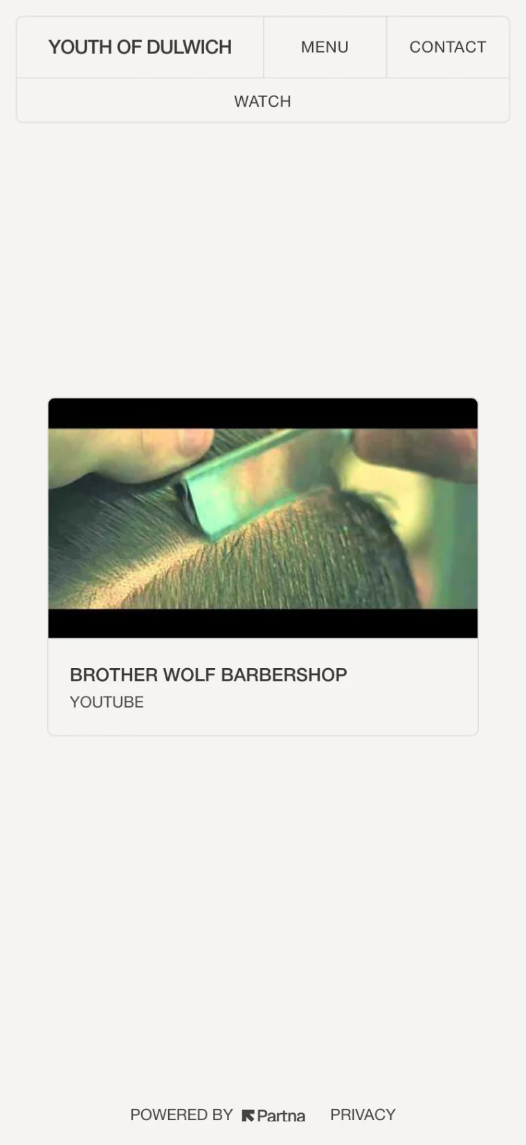 A barbershop's Milkcrate site: its Watch page with a YouTube video card